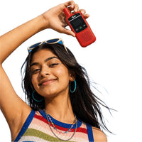 Woman holding a red TWM Talkie above her head