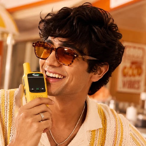 Man talking into a yellow TWM Talkie